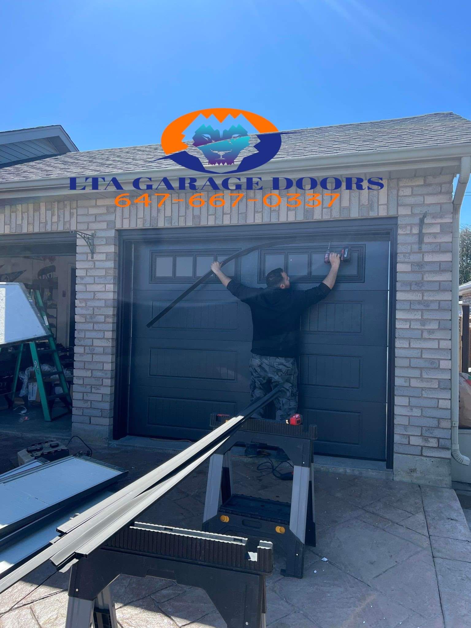 LTA Garage Doors branded photo of a technician installing a dark garage door at house 725