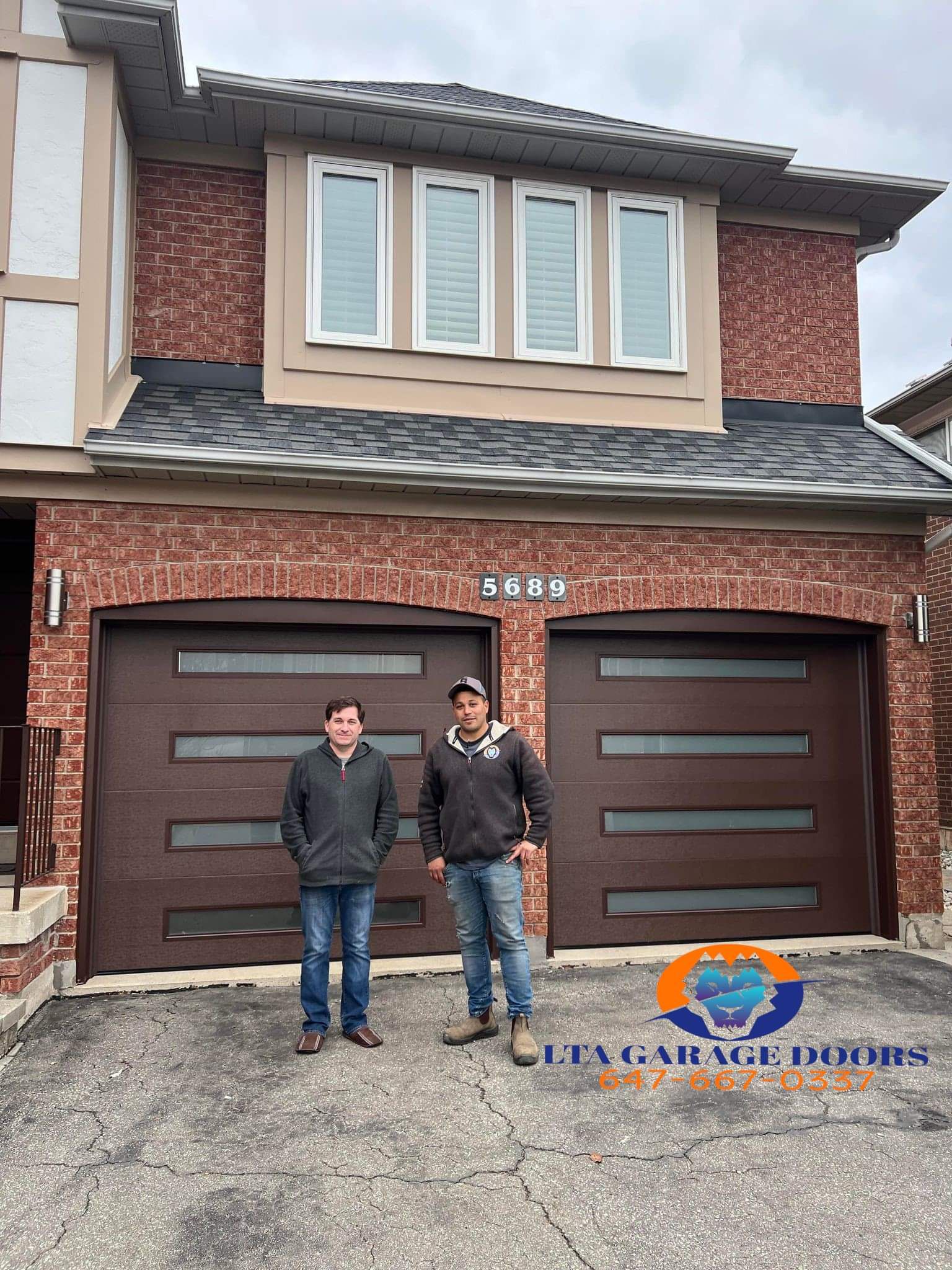 LTA Garage Doors branded team photo in front of two dark walnut contemporary garage doors at house 5689